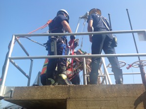 Rescue crews work to free a water plant employee trapped in a 22' pit.