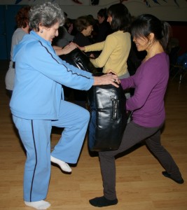 Joyce Murphy (left), Bixia Pan (right) practice self defense moves during the Women’s Self Defense Workshop taught by Shifu Billy Greer (photo by Nancy Greer)