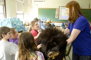 Kerry Wixted shows a black bear hide to Carson, Madeline, and Charlotte Dove, aged 13, 11, and 9, and Rebecca Stapleton, a teacher at Carrie Weedon