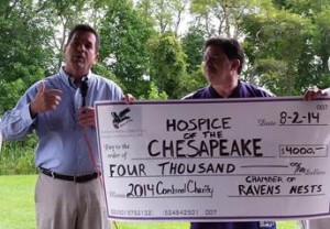 Michael S. McHale, President & CEO, Hospice of the Chesapeake, left, accepts $4,000 donation from Phil Franco of the Chamber of Ravens Nests. 