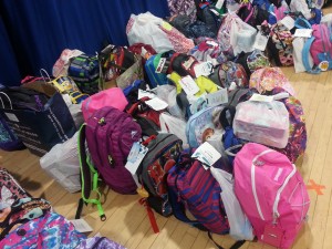 The backpacks line up along the floor of the cafeteria at Tyler Heights. Supplies were collected for students from pre-k through fifth grade.  