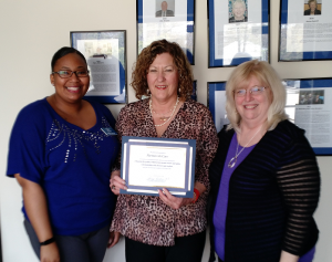 Katherine Gravelle, center, owner of the local Griswold Home Care franchise in Severna Park, presents a $1,000 check to Partners In Care’s CEO Barbara Huston, right, and Member Care Coordinator Ashley Johnson, left.